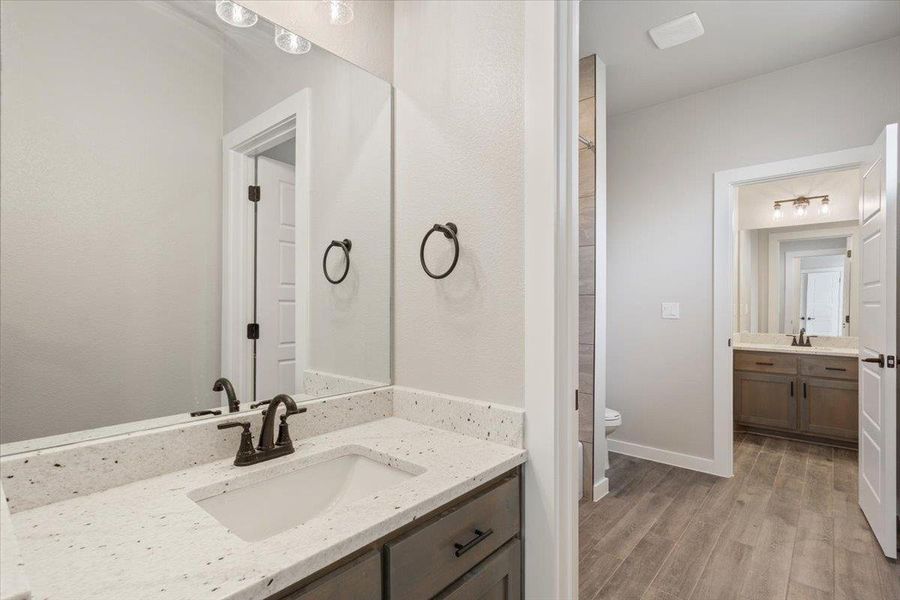 Full bath featuring vanity and light wood-style floors