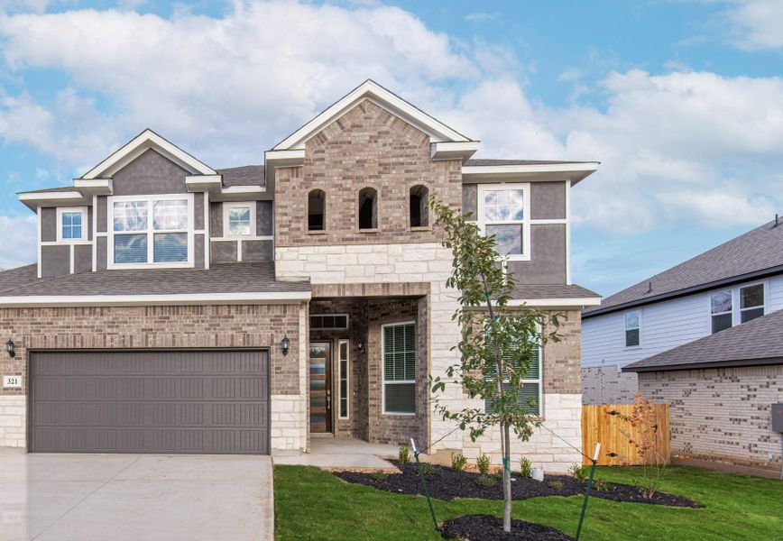 Representative exterior photo of a completed home built from the Maddie by Chesmar Homes in Stillwater Ranch, San Antonio, TX (Image 1).