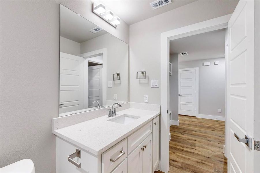 Bathroom featuring hardwood / wood-style floors and vanity