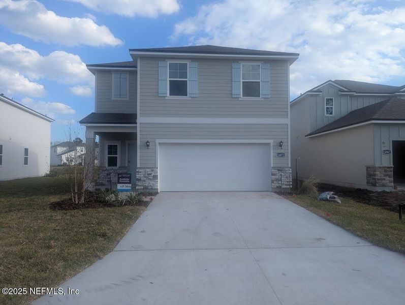 Front exterior of a new home in Palm Series at The Landings at Pecan Park, Jacksonville, FL, highlighting curb appeal (Image 1). Front exterior of a new home in Palm Series at The Landings at Pecan Park, Jacksonville, FL, highlighting curb appeal (Image 1).