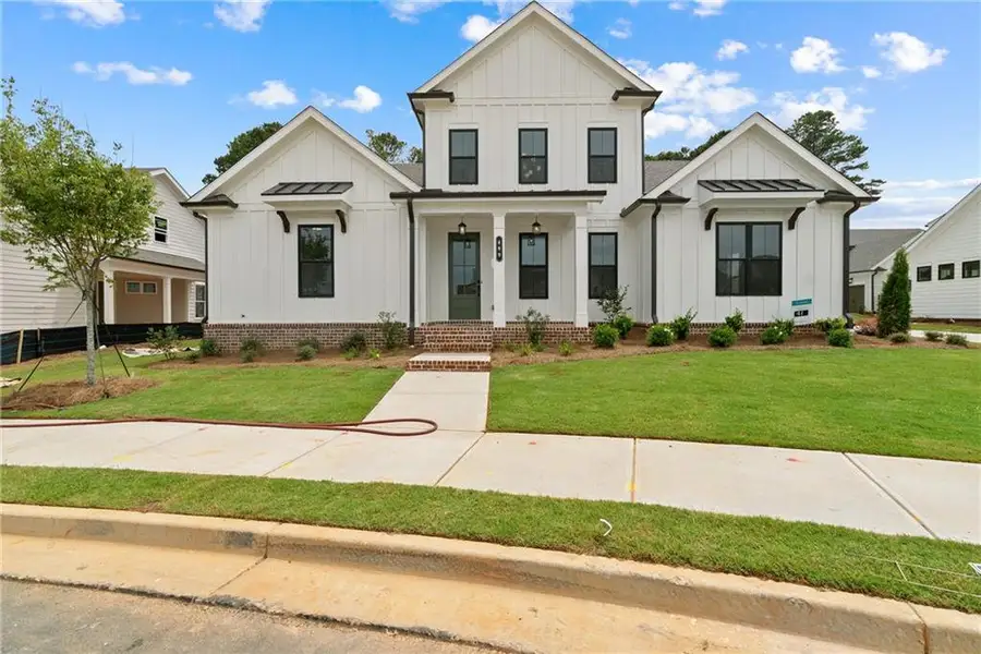 Front exterior of a new home in Promenade at Sawnee Village, Cumming, GA, highlighting curb appeal (Image 18).