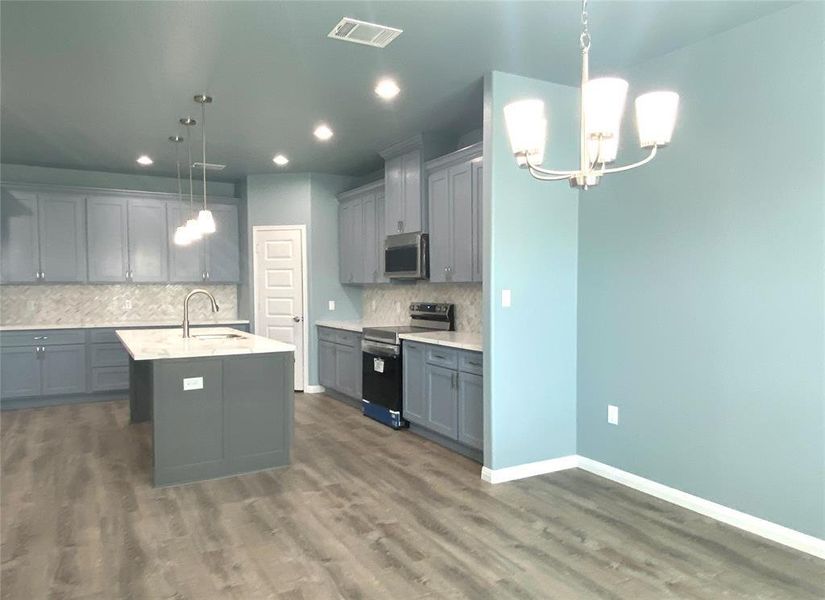 A well-appointed kitchen features a large island and ample cabinet space, perfect for culinary endeavors. A well-appointed kitchen features a large island and ample cabinet space, perfect for culinary endeavors.