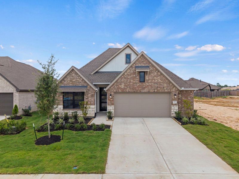 Front exterior of a new home in The Trails, New Caney, TX, highlighting curb appeal (Image 18).