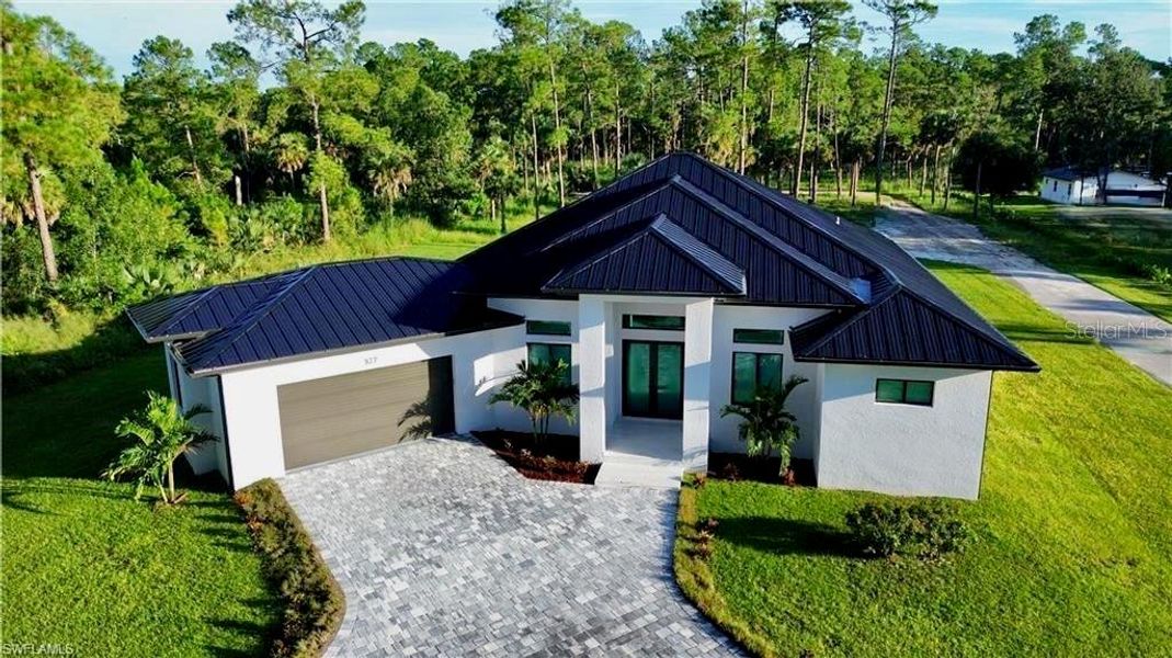 Front exterior of a new home in , Naples, FL, highlighting curb appeal (Image 1). Front exterior of a new home in , Naples, FL, highlighting curb appeal (Image 1).