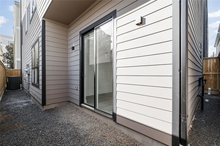 A rare luxury in urban living, this private yard extends the functionality of the first-floor suite, creating a quiet outdoor retreat ideal for morning coffee or weekend lounging. Framed by clean fencing and sheltered by modern architecture, it’s a compact escape designed for easy enjoyment.