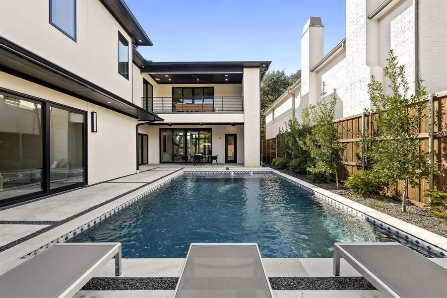 View of swimming pool featuring a fenced backyard, a patio, and a balcony View of swimming pool featuring a fenced backyard, a patio, and a balcony