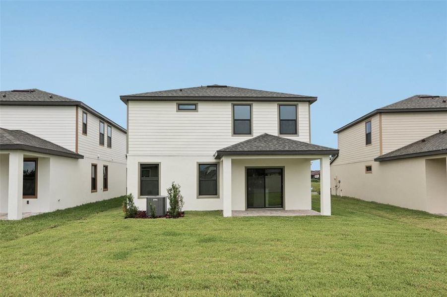 Front exterior of a new home in Grasslands West, Lakeland, FL, highlighting curb appeal (Image 20).