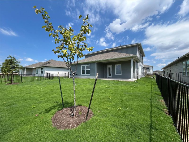 Rear view of house featuring a patio area and a fenced backyard
