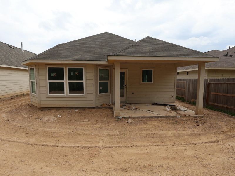 Front exterior of a new home in Pinewood at Grand Texas, New Caney, TX, highlighting curb appeal (Image 1).