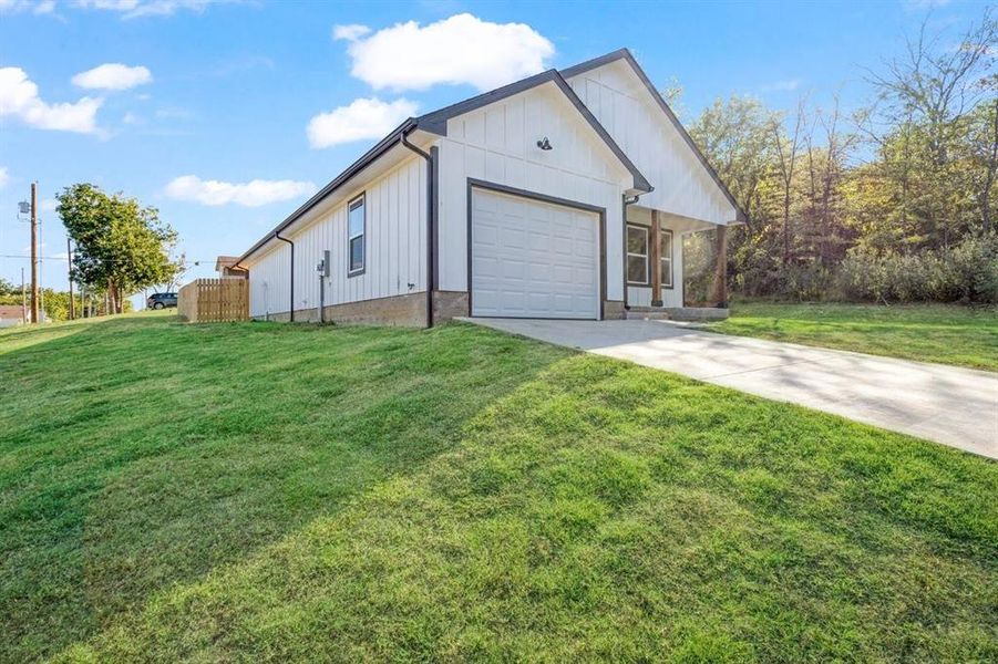 View of front of property with a garage and a front yard