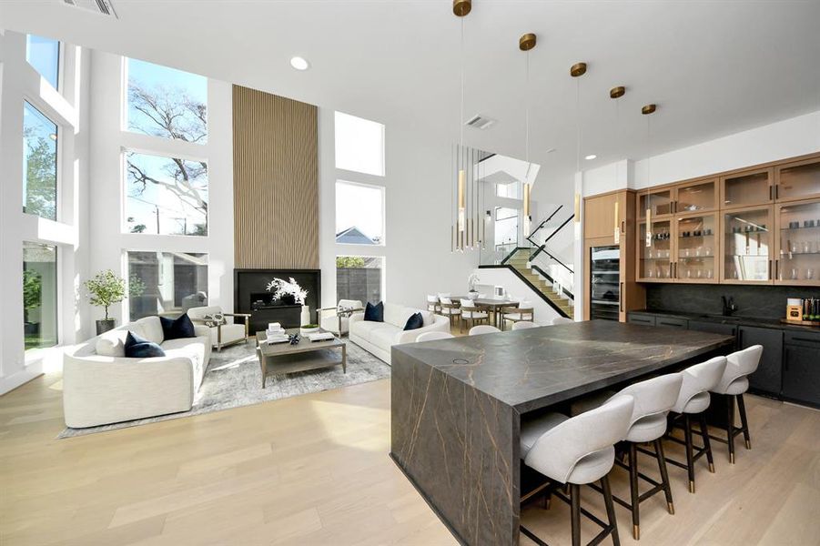 View from the sleek, modern kitchen to the spacious living area, showcasing an open floor plan.