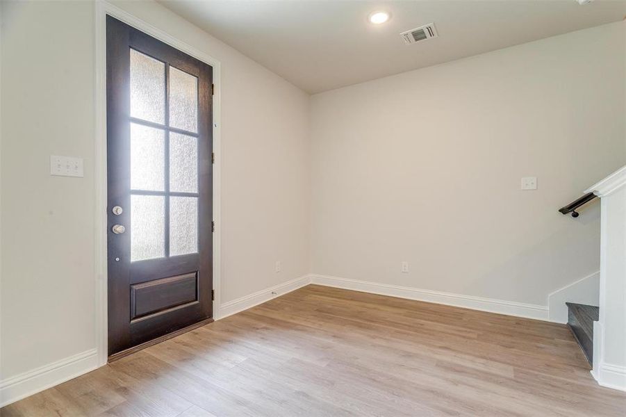 Foyer featuring a wealth of natural light and light wood-type flooring