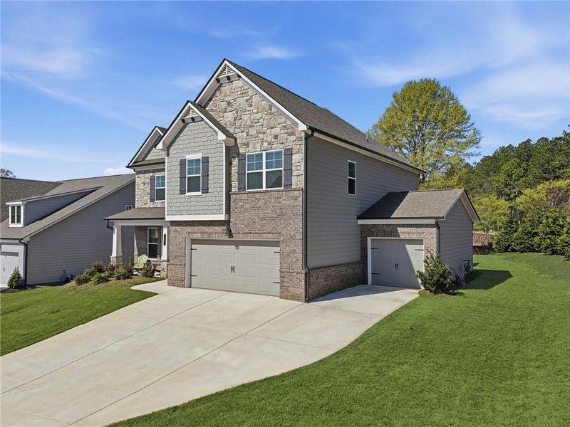 Front exterior of a new home in Rosewood Lake Estates, Hoschton, GA, highlighting curb appeal (Image 28). Front exterior of a new home in Rosewood Lake Estates, Hoschton, GA, highlighting curb appeal (Image 28).