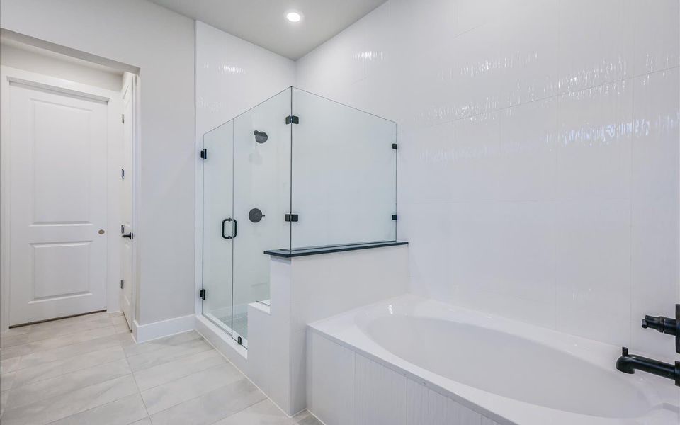 Full bathroom featuring a shower stall, a bath, light tile patterned floors, and recessed lighting