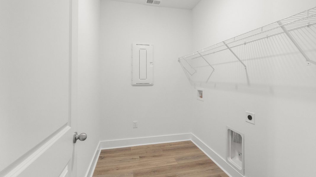 Convenient laundry room with storage shelf and utility connections. Convenient laundry room with storage shelf and utility connections.