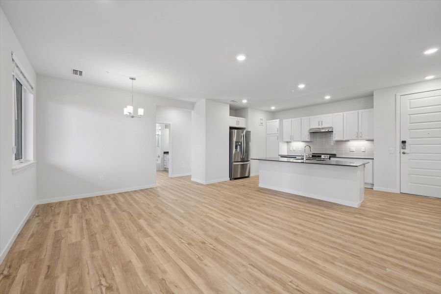 A large kitchen with white cabinets. A large kitchen with white cabinets.