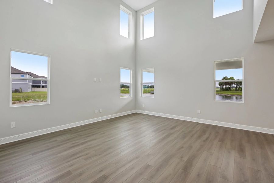 Off the kitchen and dining nook is the two story family room featuring six large windows