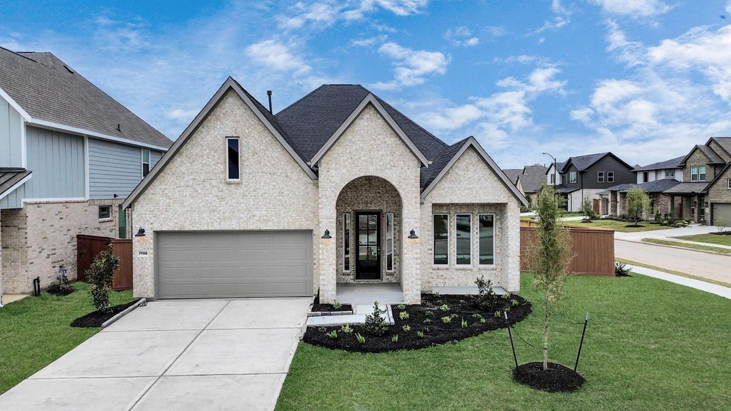 Front exterior of a new home in 50' Traditional Homes at Elyson, Katy, TX, highlighting curb appeal (Image 1). Front exterior of a new home in 50' Traditional Homes at Elyson, Katy, TX, highlighting curb appeal (Image 1).