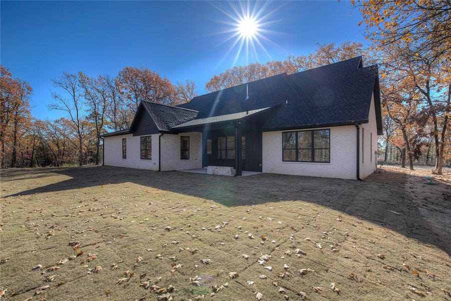 Deep back porch with cedar beams provides an oasis to watch kids play on your sodded lawn.