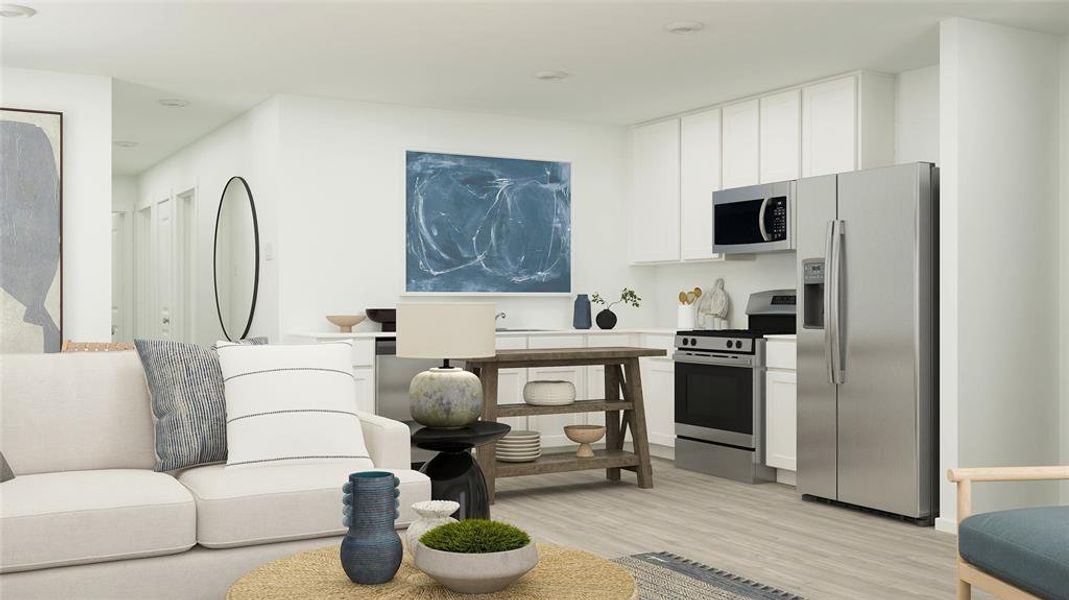 Kitchen featuring white cabinetry, light wood-type flooring, and appliances with stainless steel finishes