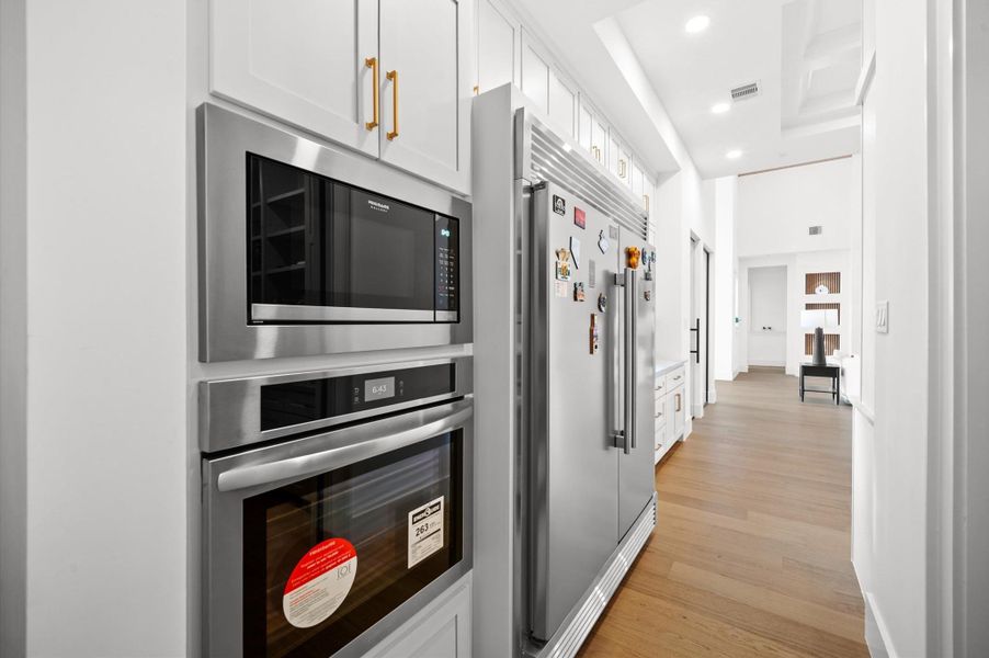 Professional-grade appliances complement the thoughtfully designed workspace.