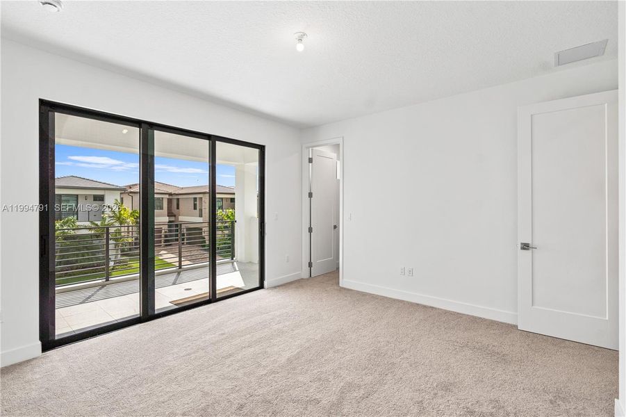 2nd bedroom with balcony and walk-in closet