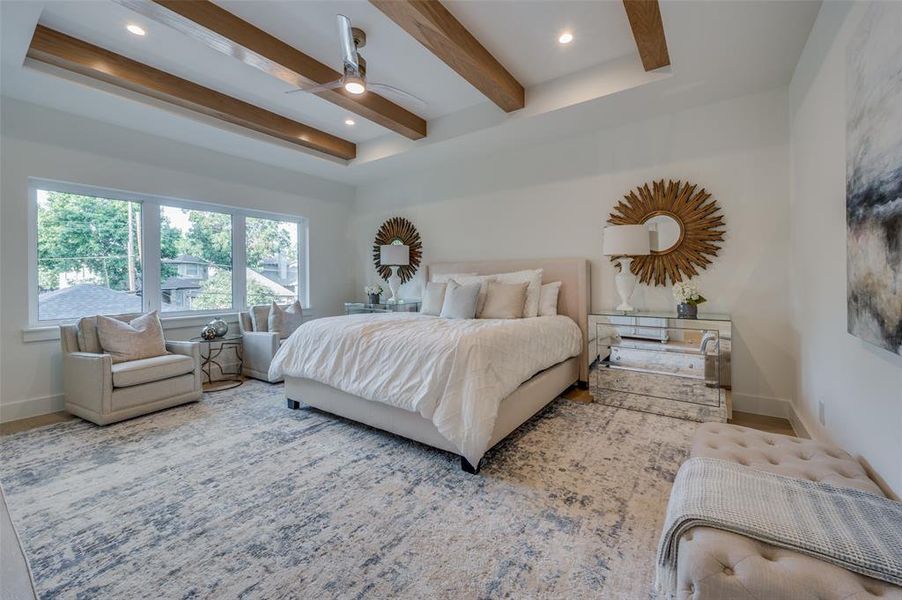 Bedroom with ceiling fan and beamed ceiling