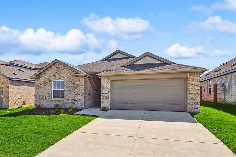 View of front of property with a garage and a front yard