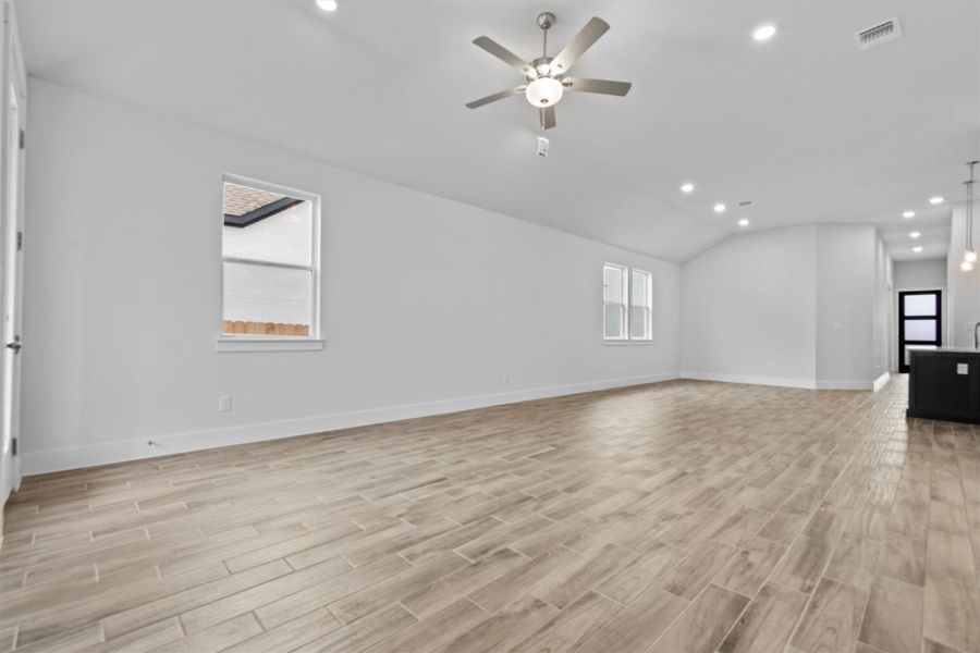 Spare room with lofted ceiling and ceiling fan