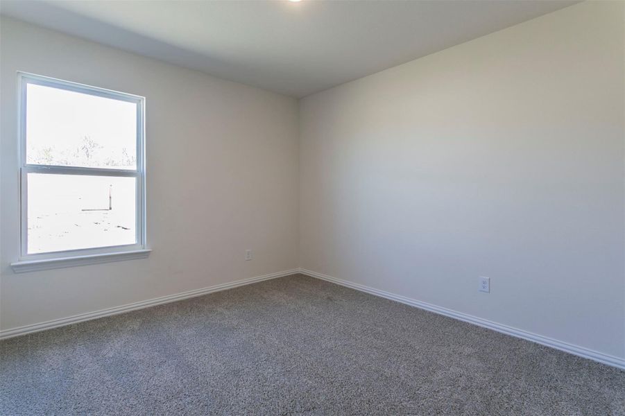 Spare room featuring baseboards, a healthy amount of sunlight, and carpet Spare room featuring baseboards, a healthy amount of sunlight, and carpet