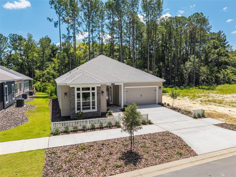 Front exterior of a new home in Fairway Pointe at West End, Newberry, FL, highlighting curb appeal (Image 1). Front exterior of a new home in Fairway Pointe at West End, Newberry, FL, highlighting curb appeal (Image 1).
