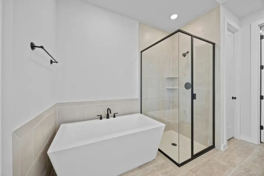 Full bathroom with a freestanding tub, a stall shower, and recessed lighting Full bathroom with a freestanding tub, a stall shower, and recessed lighting