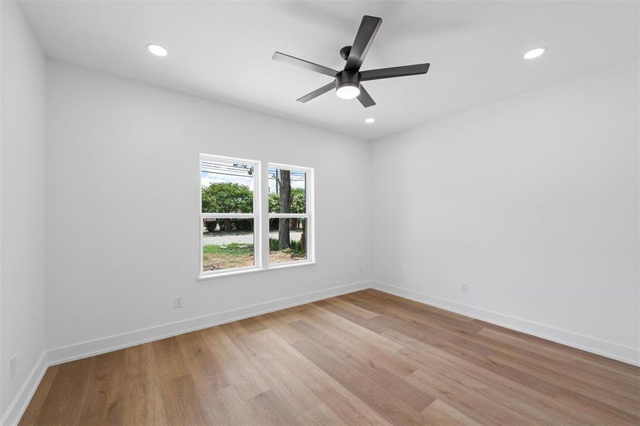 Spare room with light wood-style flooring, ceiling fan, and recessed lighting Spare room with light wood-style flooring, ceiling fan, and recessed lighting