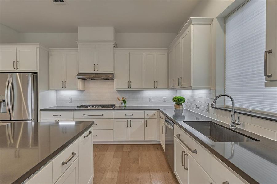 Soft closing cabinets and drawers throughout, quartz countertops, and 5-burner cooktop are only a few of the appointments in this desirable kitchen!