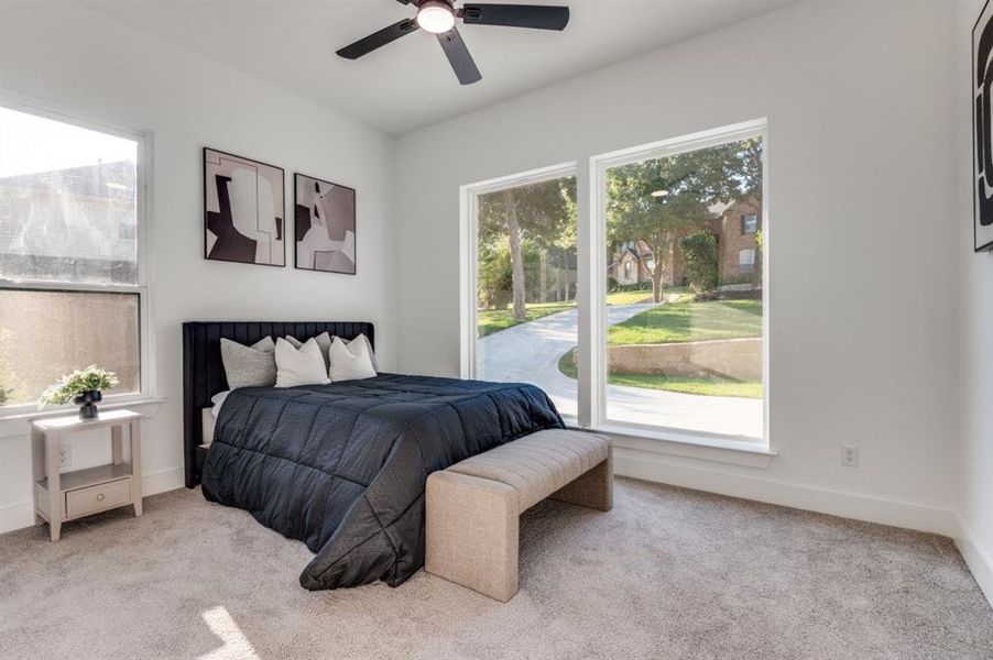 Bedroom featuring carpet floors and a ceiling fan Bedroom featuring carpet floors and a ceiling fan