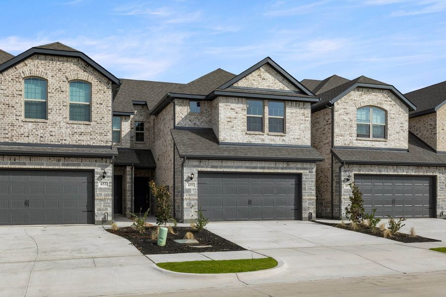 Front exterior of a new home in Main Street Village, Mansfield, TX, highlighting curb appeal (Image 2). Front exterior of a new home in Main Street Village, Mansfield, TX, highlighting curb appeal (Image 2).