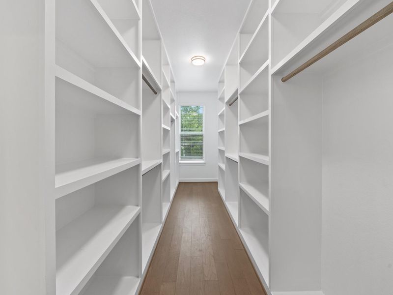 Step into a deeply designed primary closet offering exceptional storage space, smart organization, and room to spare—perfect for keeping your wardrobe effortless and clutter-free. Image depicts home as-is.