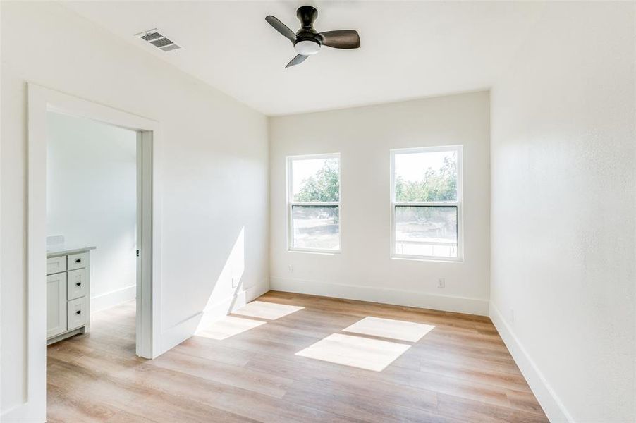 Spare room with ceiling fan and light hardwood / wood-style flooring