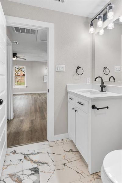 Hall Bathroom with vanity and light marble finish flooring