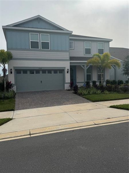 Front exterior of a new home in Willow Ridge, Montverde, FL, highlighting curb appeal (Image 6).