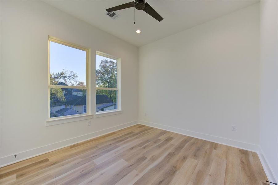 Guest Bedroom 1. Home comes with LED recessed lighting and ceiling fans pre-installed in all rooms.