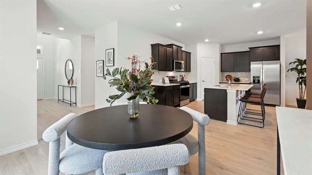 Dining room featuring light wood-type flooring and recessed lighting