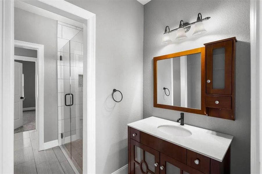 Full bath featuring vanity and a stall shower