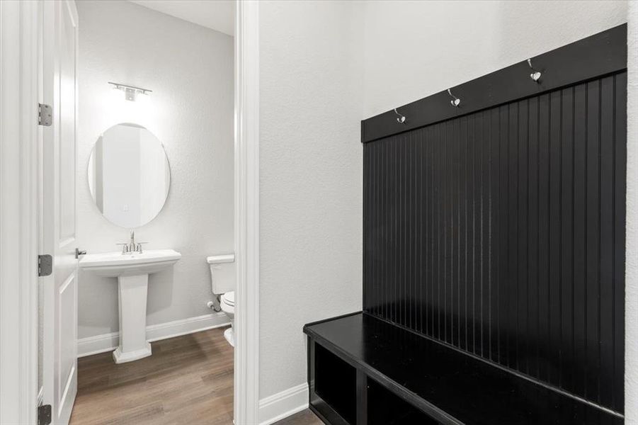 Mudroom featuring wood finished floors and a textured wall