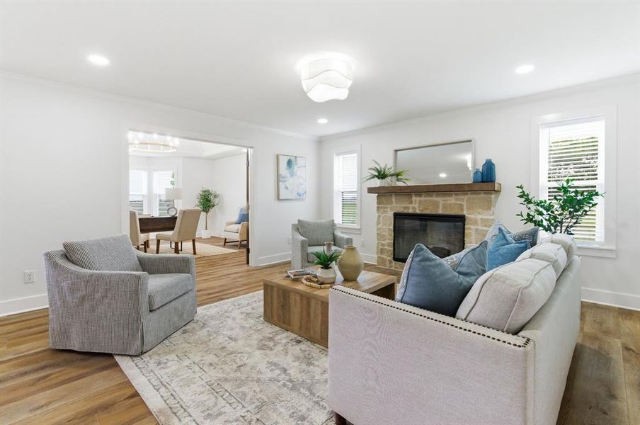 Inviting living area featuring light-toned walls, recessed lighting, and wooden flooring Inviting living area featuring light-toned walls, recessed lighting, and wooden flooring