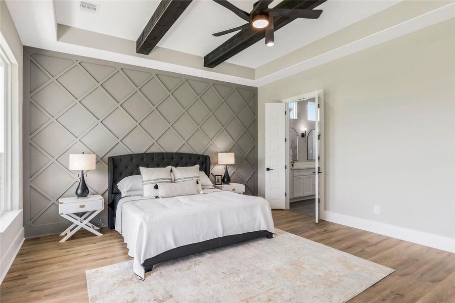 Primary bedroom leads into en-suite bathroom through double doors Primary bedroom leads into en-suite bathroom through double doors