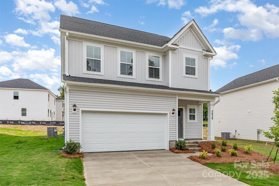 Double-car garage & concrete driveway. Representative Photo.