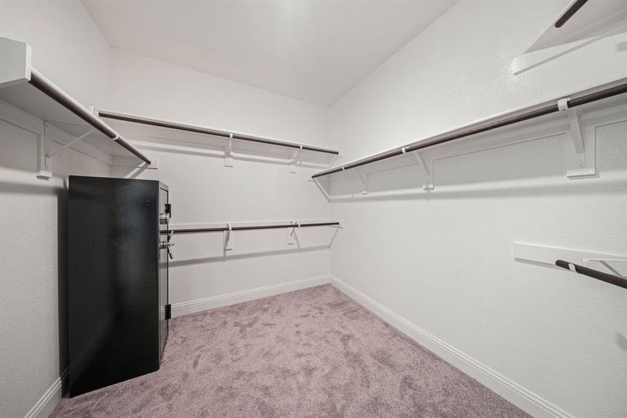 Walk-in primary bedroom closet.