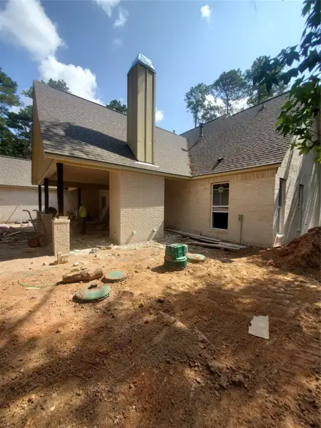 BACK PATIO WITH OUTDOOR FIREPLACE COMPLETE AND OUTDOOR KITCHEN BEING INSTALLED