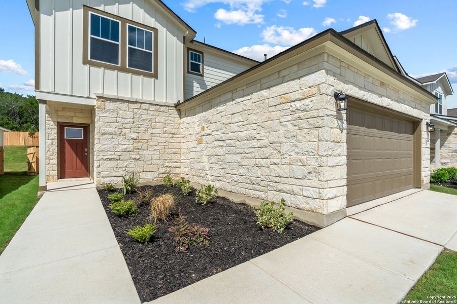 Front exterior of a new home in The Meadows at Hunters Ranch, San Antonio, TX, highlighting curb appeal (Image 19).